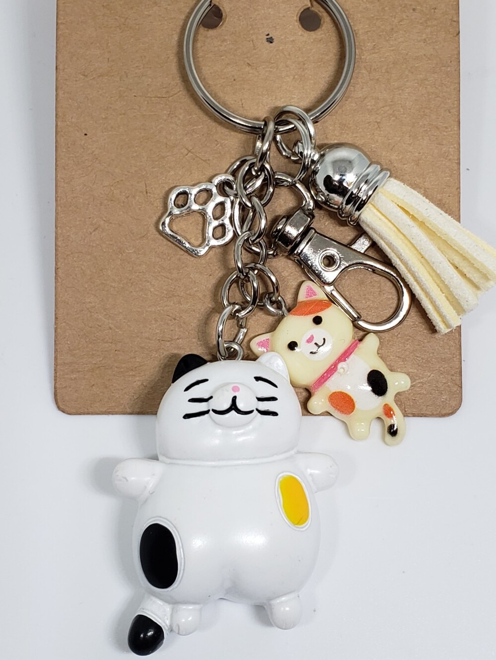 Handmade painted resin calico cat paw keychain